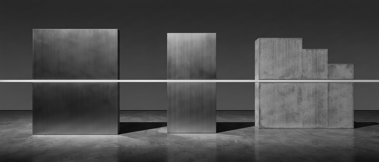 Conceptual editorial illustration — three distinct architectural volumes of different materials connected by one thin horizontal line of light passing through all three. Monochrome study of banks, wallets and tokens as connected but distinct forms.